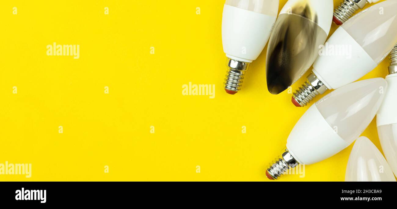Burned LED light bulb. Concept of electrical short circuit. Burning wire in house, dangerous