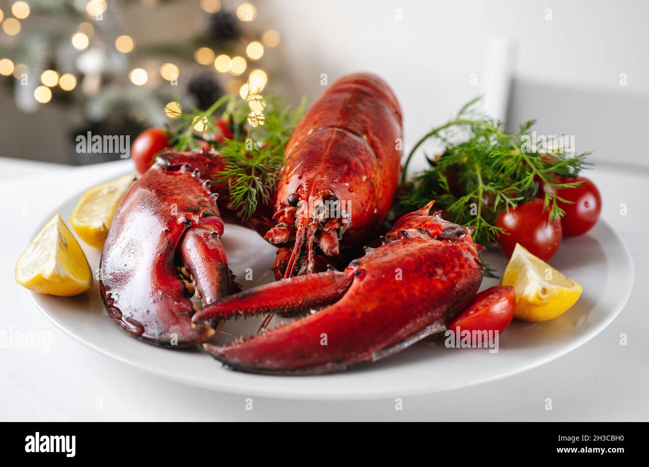 Freshly cooked lobster with vegetables on a plate Stock Photo