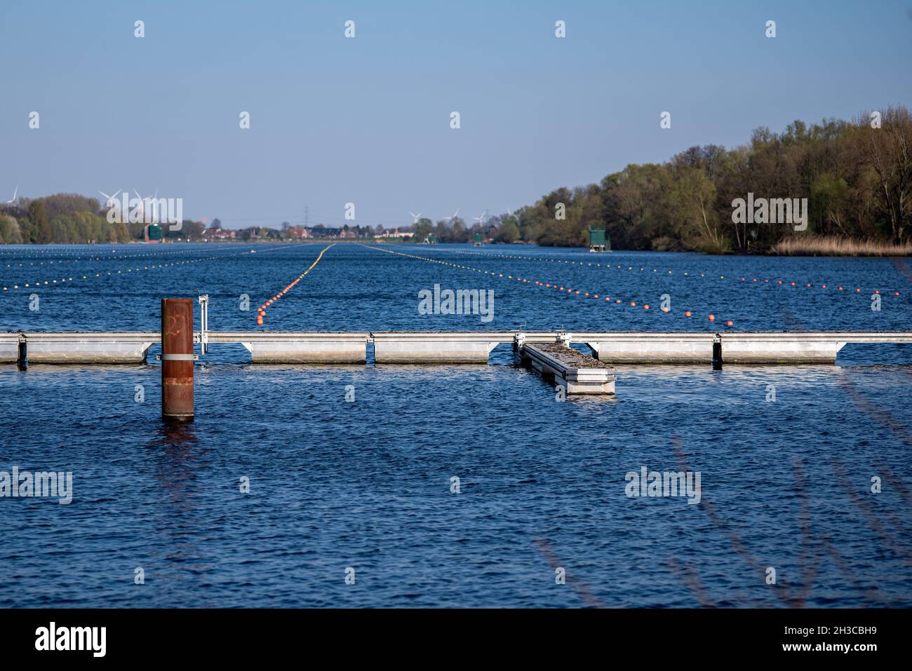River with barriers and markings in the water for rowing competitions ...