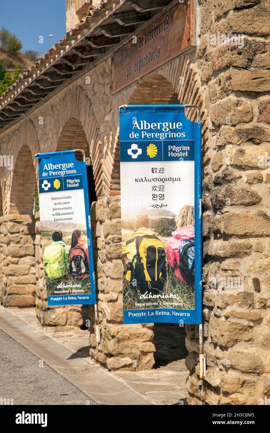 Pilgrims outside the albergue de Peregrinos in the Spanish town of Puente La Reina while walking the Camino de Santiago the way of St James Stock Photo