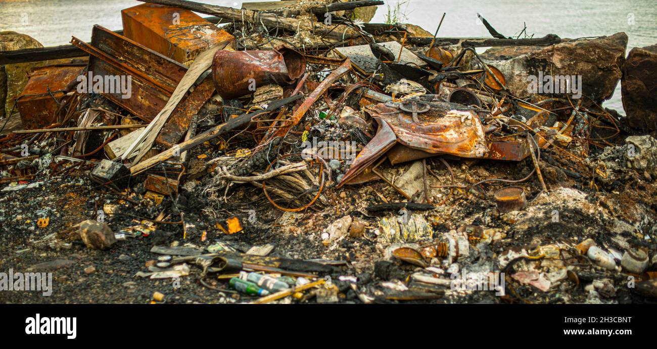 Metallic remnants after a garbage fire Stock Photo