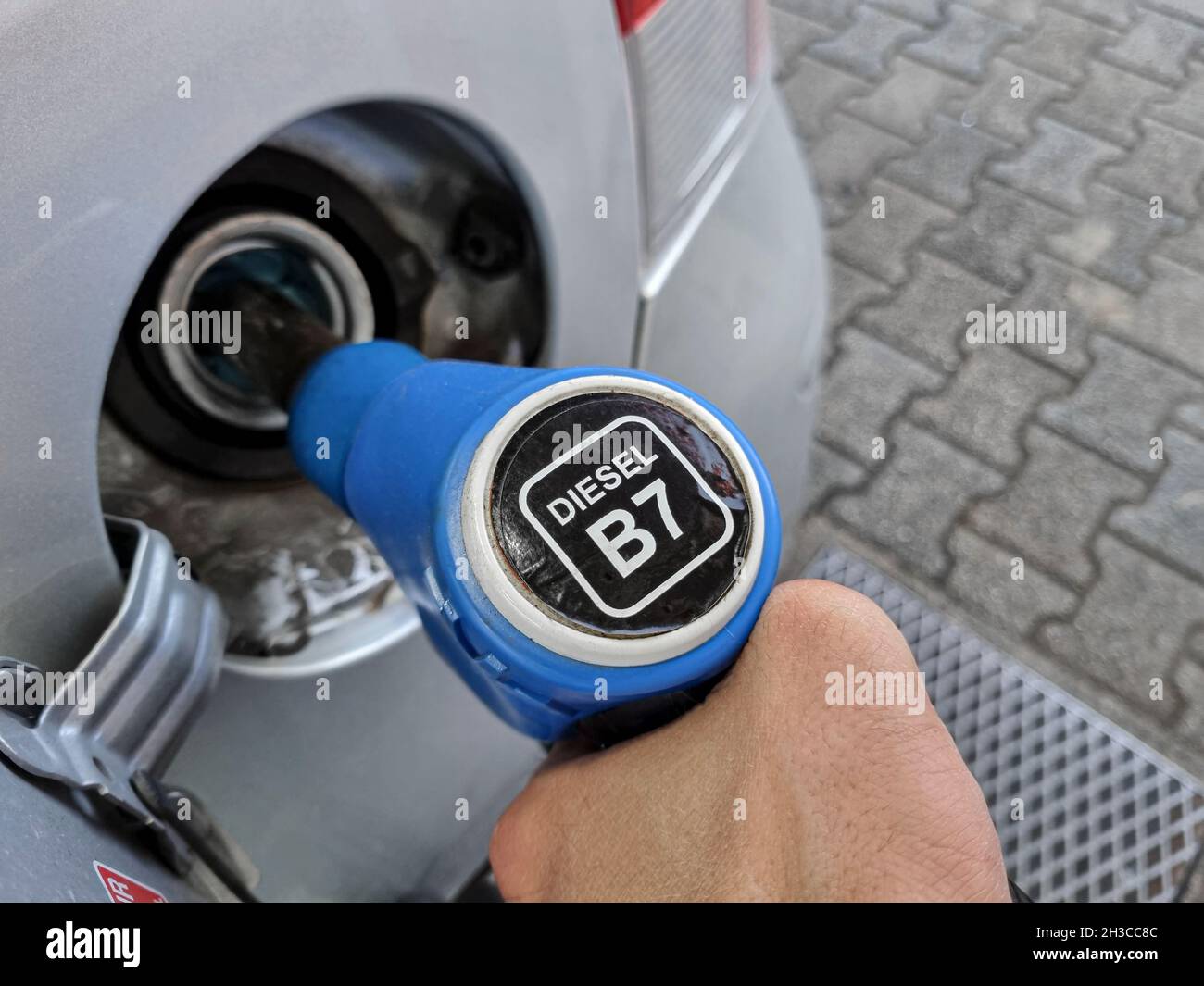 Man at Gas station while refueling a car,increasing petrol costs concept Stock Photo