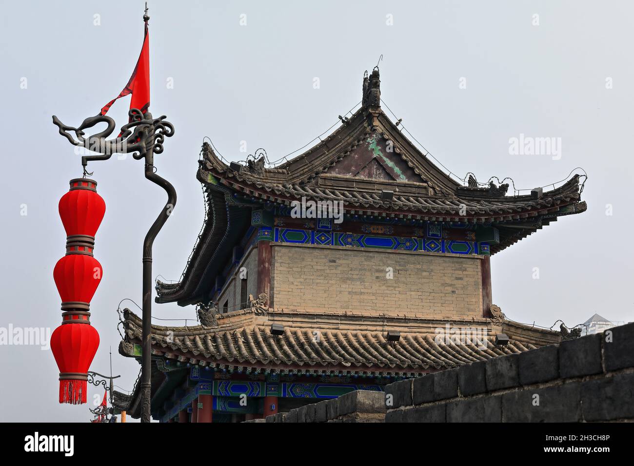 Sentry building-red pennant-Chinese lanterns-iron flagpole-City Wall's Yongning South Gate. Xi'an-China-1594 Stock Photo