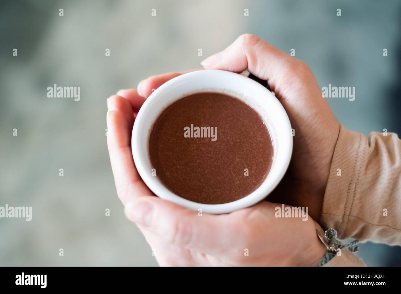 Cacao ceremony. Female hand holding a cup of pure shamanistic ...