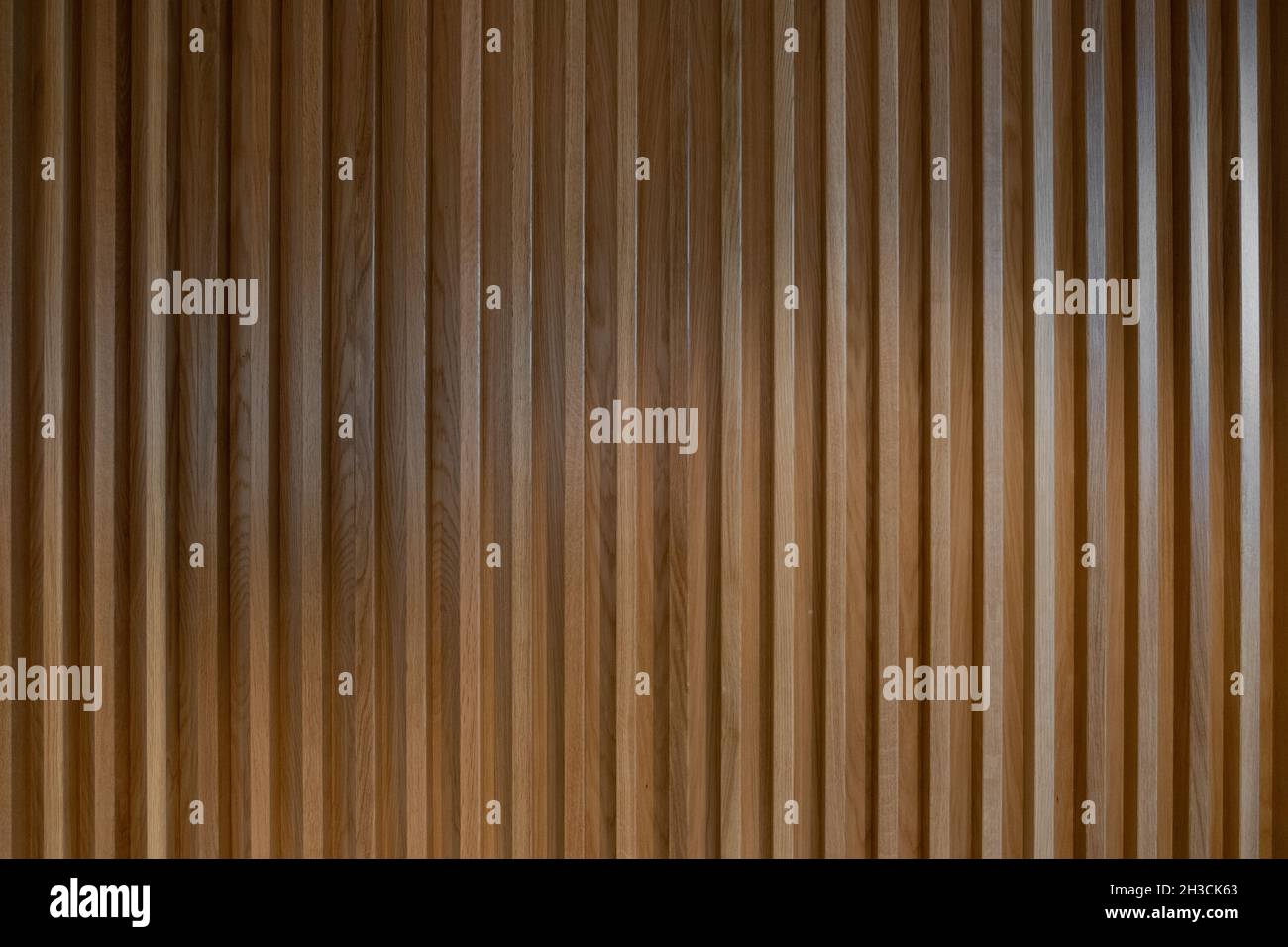 Ribbed wood wall background. Wooden textured panel. Interior design detail. Stock Photo