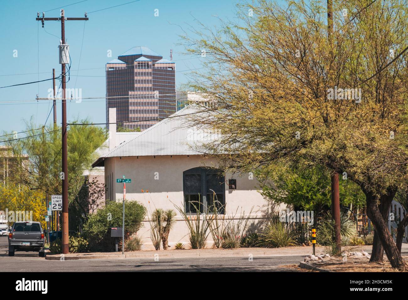 A high rise office building in downtown Tucson looms over a more traditional residential home in