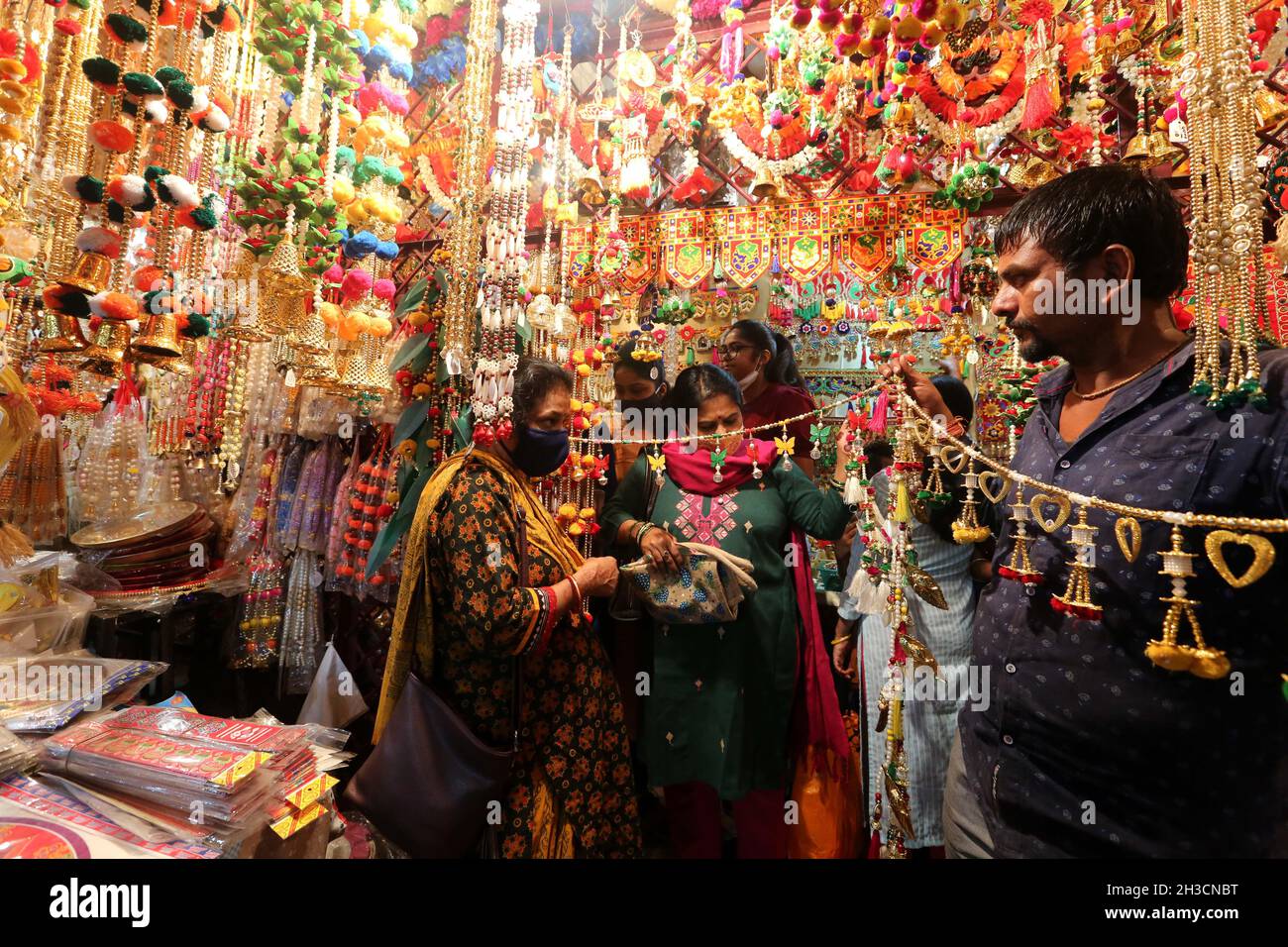 Bhopal, India. 27th Oct, 2021. People shop for decorative items at a