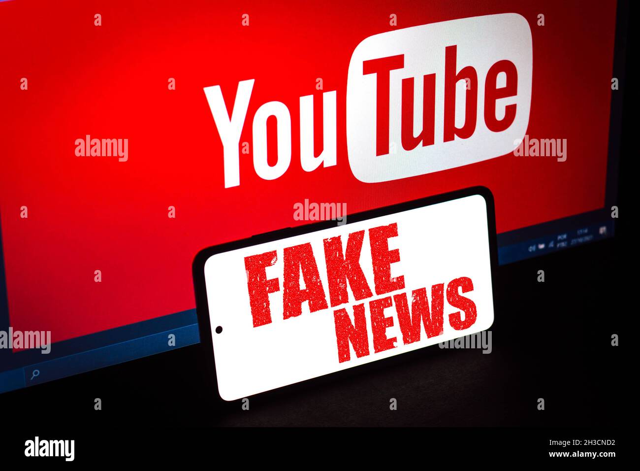 In this photo illustration, the red alerting word 'fake news' is displayed  on a smartphone and a YouTube logo on the blurred background. (Photo by  Rafael Henrique / SOPA Images/Sipa USA Stock