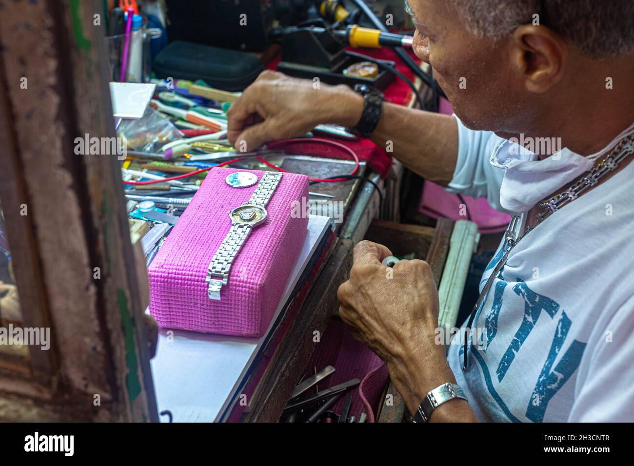 Senior male watchmaker working at workshop, Cartagena de Indias, Colombia. Stock Photo