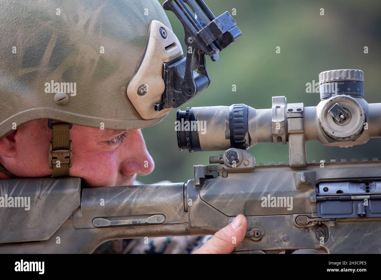 U.S. Marine Corps Cpl. Connor Swanson, a scout sniper with 2d Battalion, 3rd Marine Regiment, looks through the scope on an M110 Semi-Automatic Sniper System during a sniper shoot during Korea Marine Exchange Program 22-1 at Camp Rodriguez, Pocheon, Republic of Korea, Oct. 15, 2021. The training allowed Marines to sustain the fundamentals of marksmanship. (U.S. Marine Corps photo by Sgt. Ash McLaughlin) Stock Photo
