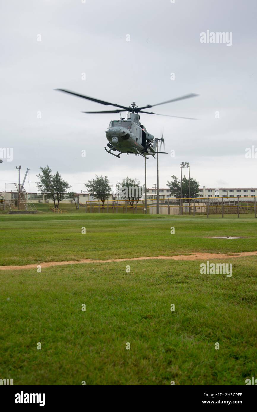 A Marine Corps UH-1Y Huey with Marine Light Attack Helicopter Squadron 169 takes off for a medical evacuation following a simulated missile strike for Exercise Constant Vigilance on Camp Schwab, Okinawa, Japan, Oct. 21, 2021. Following a simulated missile strike, Marines with MCIPAC and local emergency services conducted tactical casualty care and medical evacuation procedures, chemical radiological and nuclear containment efforts, and air transportation to simulate an emergency environment and practice response measures. Constant Vigilance is an island-wide force protection condition evaluati Stock Photo