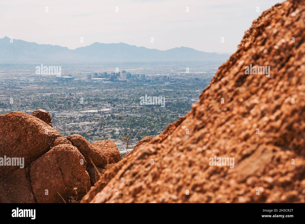 Phoenix city skyline as seen from the big red rock that is Camelback Mountain, Arizona, United States Stock Photo