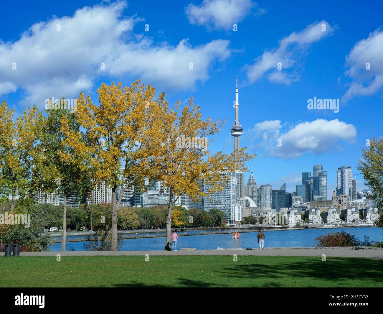 Strollers enjoy a warm fall day on the recreational trail beside Lake Ontario near downtown Toronto. Stock Photo