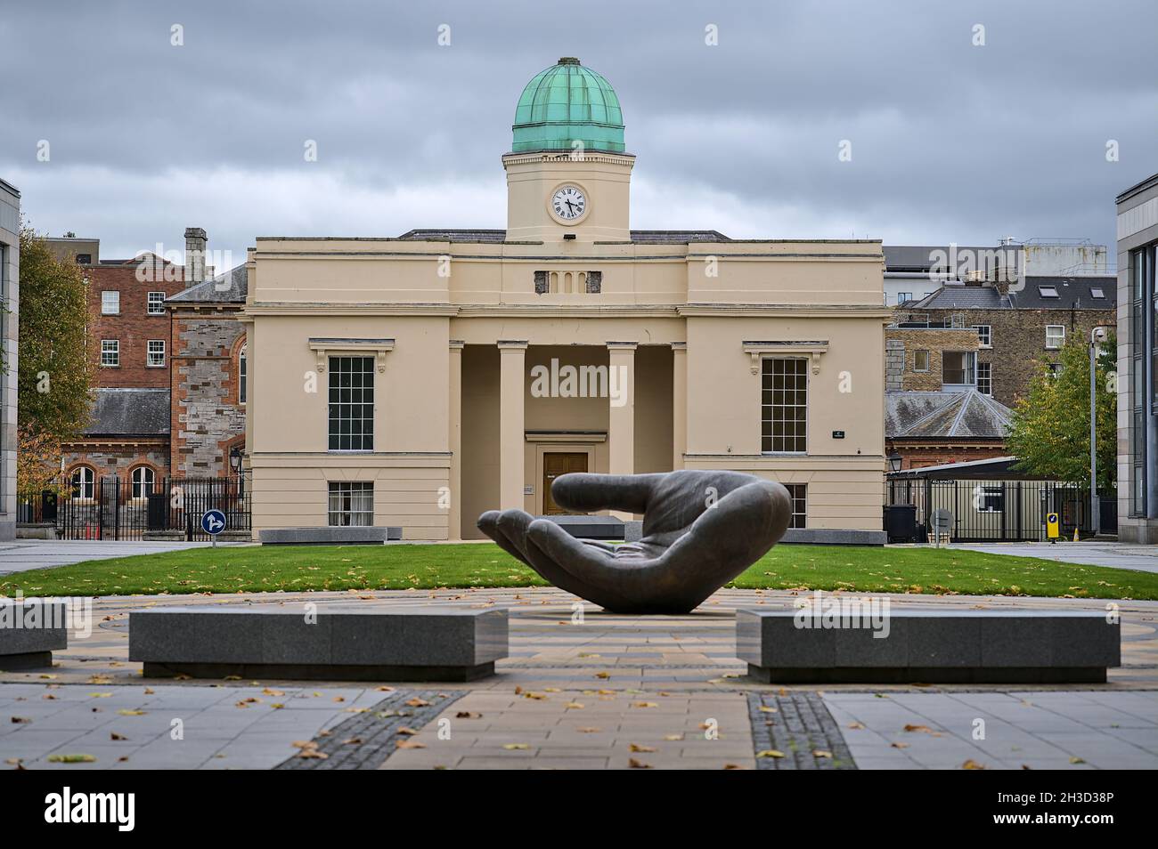 Dublin, Ireland - October 23, 2021: Autumn view of The Clock Tower building and The Wishing Hand sculpture at courtyard of Department of Education Stock Photo