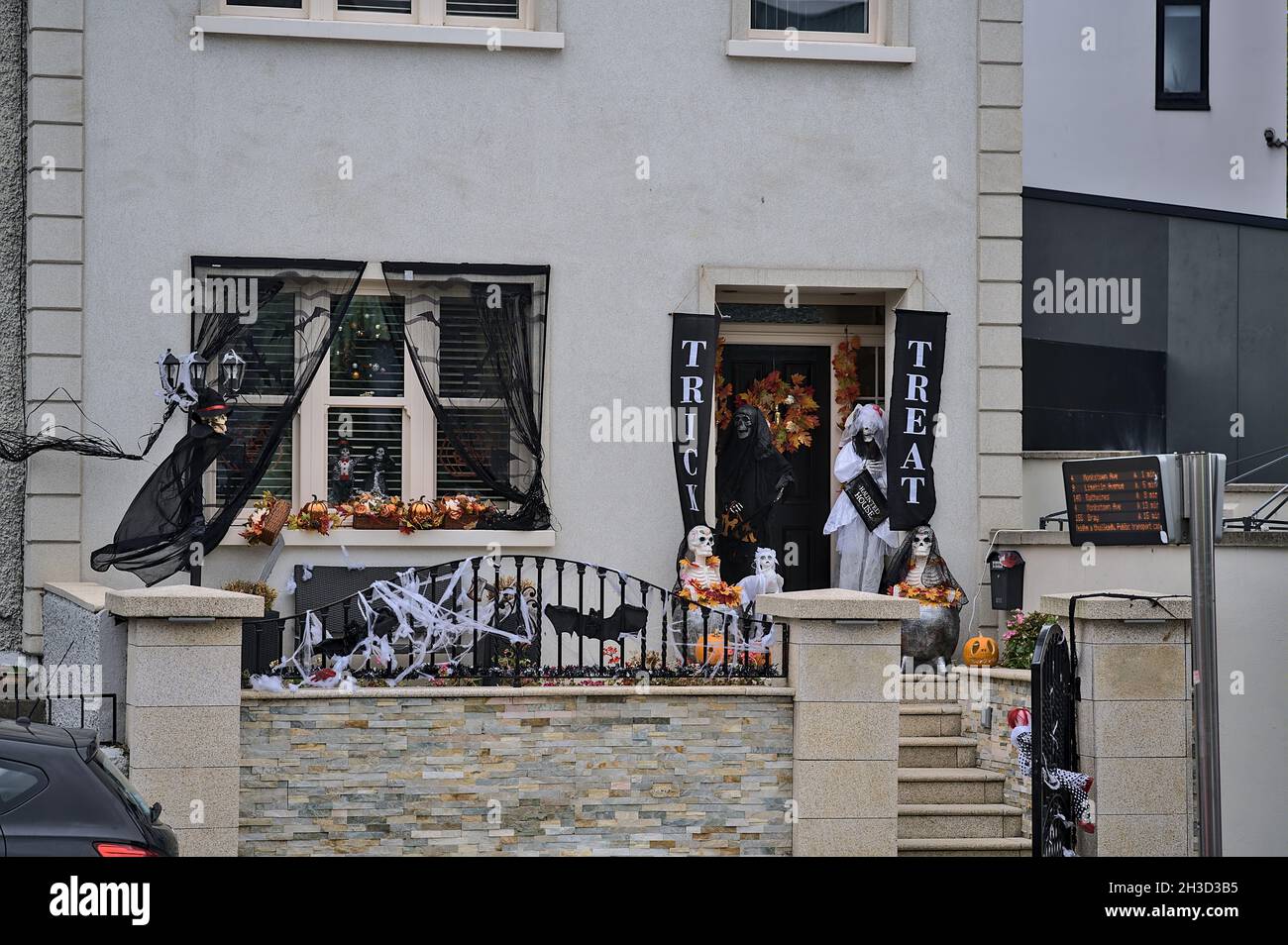 Beautiful and spooky Halloween decor on house in Dublin City Centre. Halloween 2021 decoration on the wall beside the door, Dublin, Ireland Stock Photo