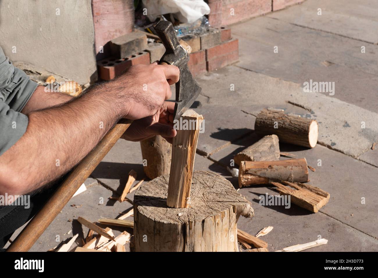 Man chopping wood with an ax. Stock Photo
