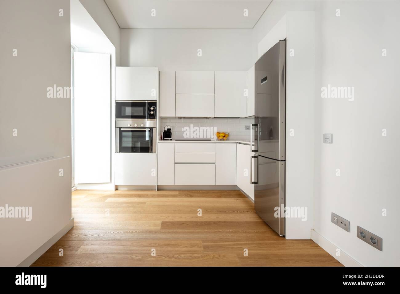 open plan kitchen of white kitchen cabinets with stainless steel ...