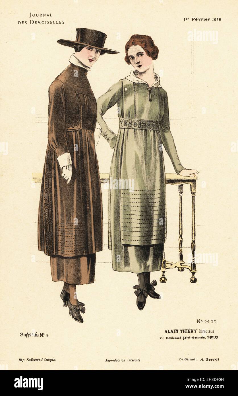 Two fashionable women in a parlor, WWI.. Both in similar dresses with tunic apron, one in a wide-brim quaker hat and gloves. Handcoloured lithograph by Fattorini & Crespin from Alain Thiery’s fashion magazine Journal des Demoiselles, 79 Boulevard Saint-Germain, Paris, France, February 1, 1918. Stock Photo