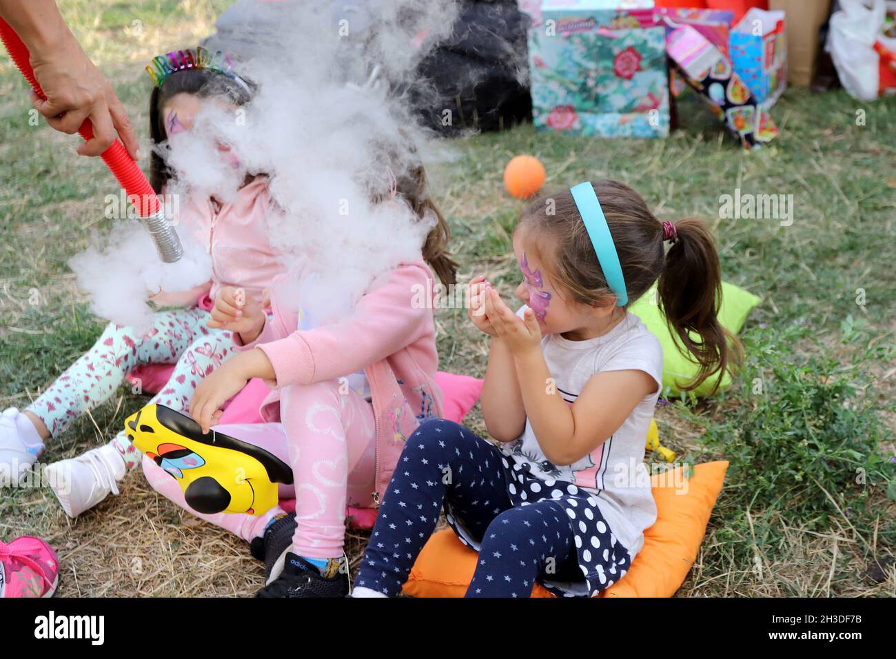 Children's birthday party with tricks and smoke from dry ice. Stock Photo