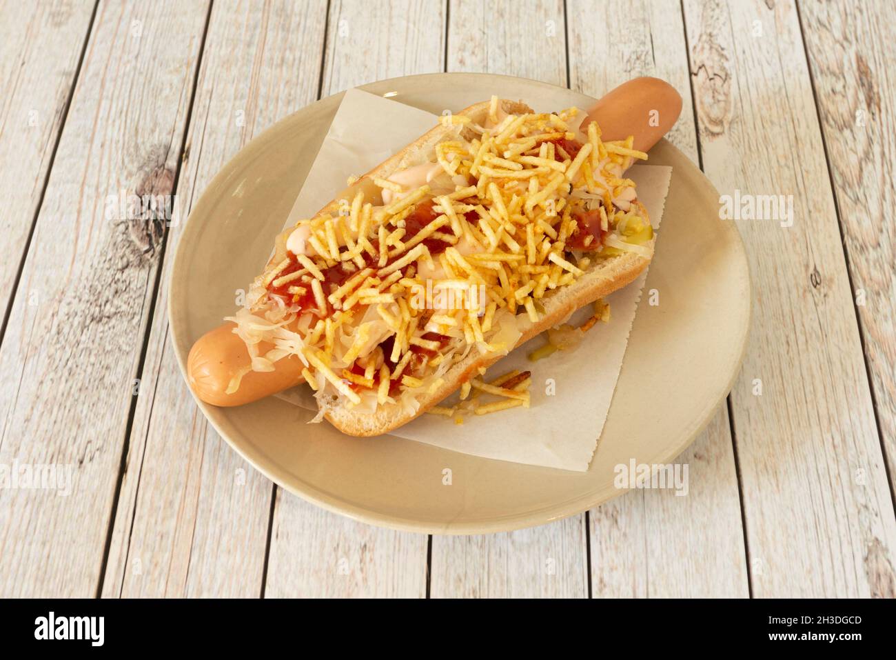Hot dog xxl with ketchup, mayonnaise and straw chips on white plate Stock Photo Alamy