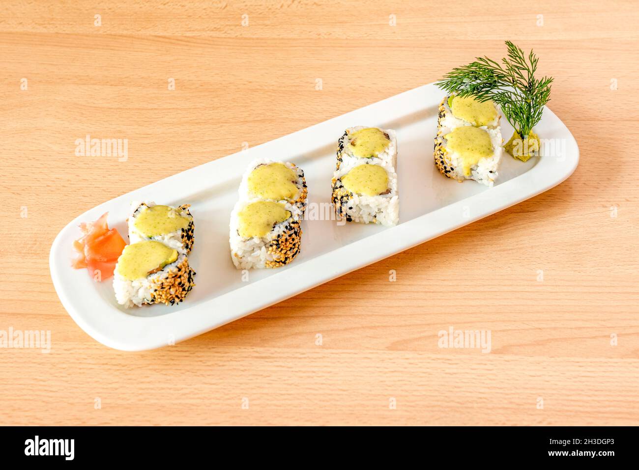 Sushi uramaki california roll with sesame and poppy seeds, yellow cream,  salmon and wasabi with fresh dill Stock Photo - Alamy
