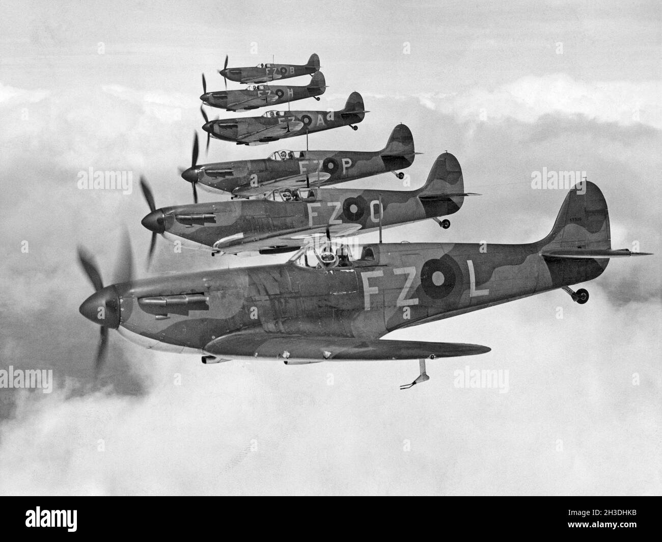 Airplane history. British fighter aircrafts, Supermarine Spitfire in the air, one in front of the other. Stock Photo