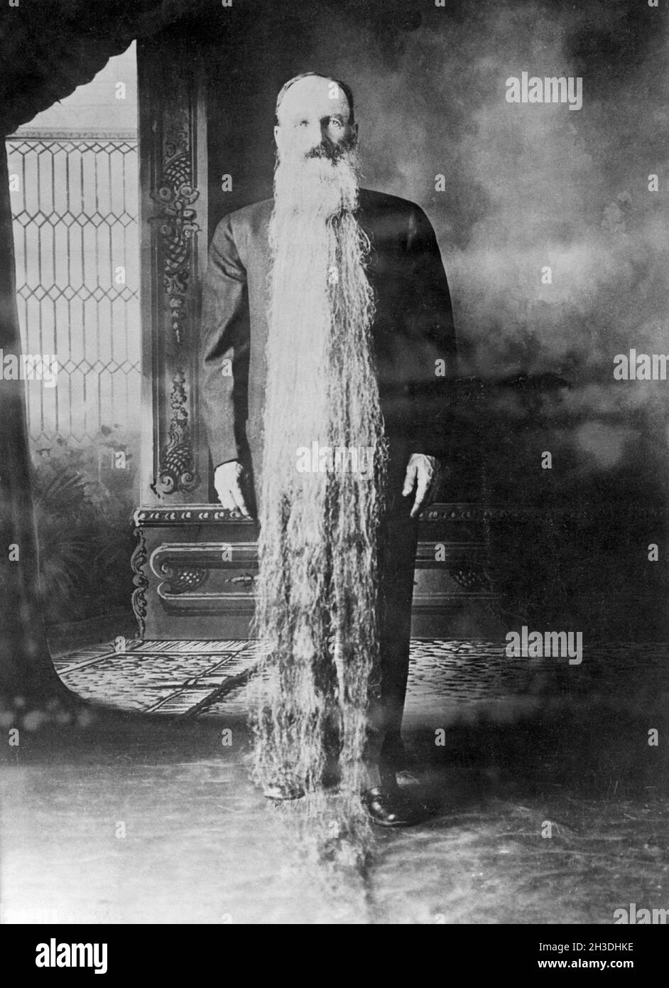 Zacharias T. Wilcox from Carson City Nevada. Famous for having a beard that is more than two meters long. He is pictured standing with the beard hanging from his head down to the floor. He was in 1922 part of a American nationwide search for the man with the longest beard and came in second-place with a length of  his beard at 12 feet. Stock Photo