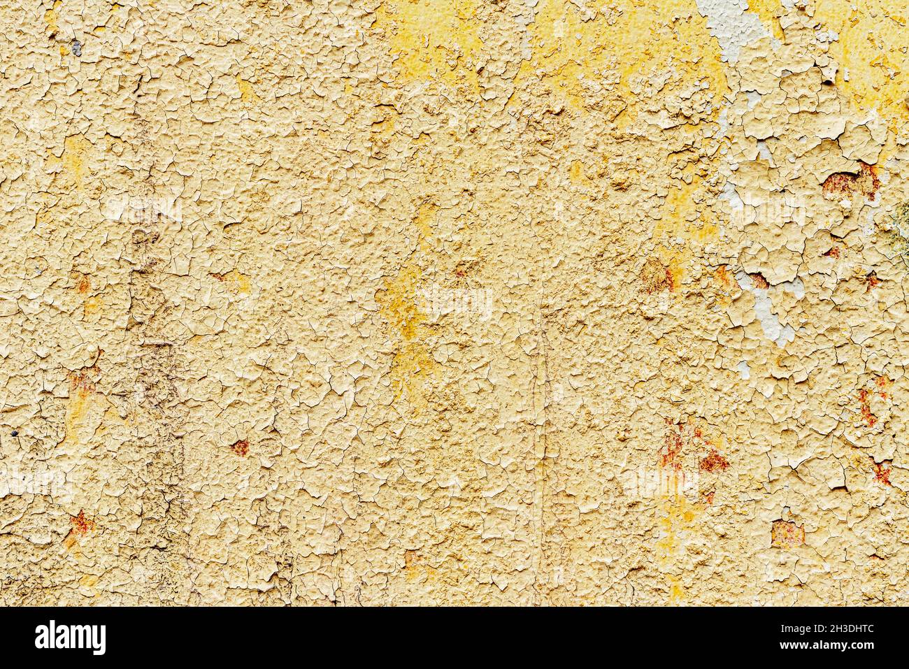 texture of old wall with a cracked golden paint. Stock Photo