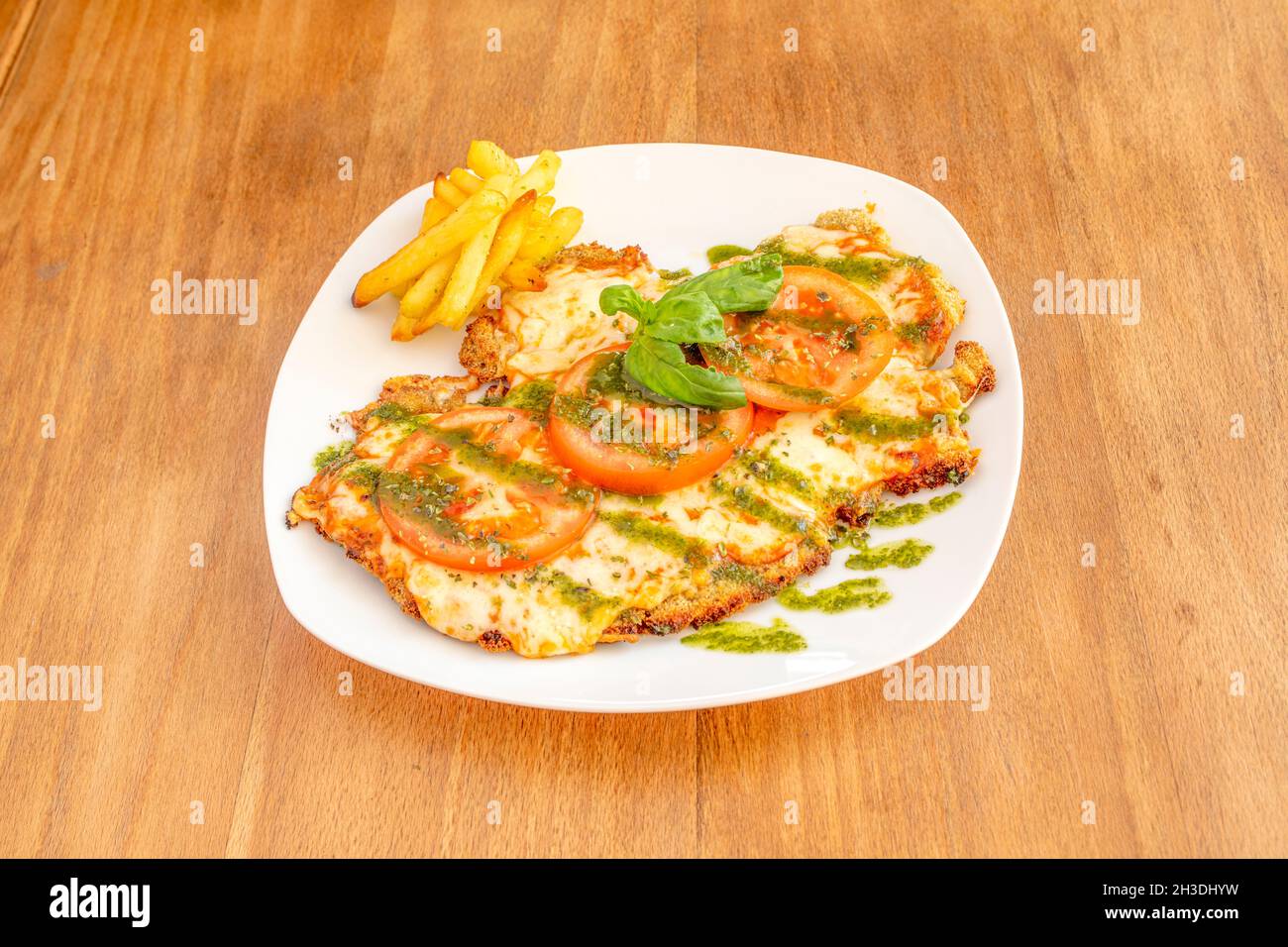 Argentinian veal schnitzel with melted mozzarella cheese, tomato slices