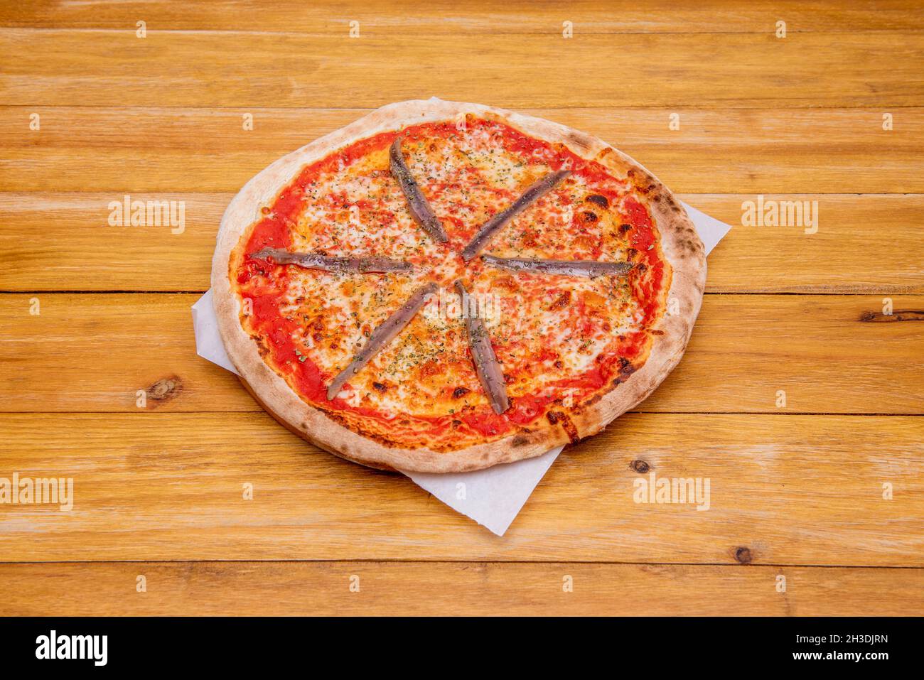 Spanish seafood pizza with mozzarella cheese with smoked Cantabrian