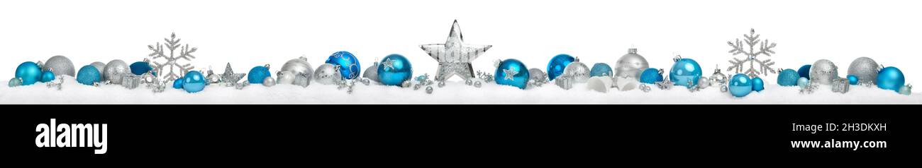 Christmas border or banner with stars and baubles arranged in a row on snow, silver and blue, extra wide and isolated on white background Stock Photo