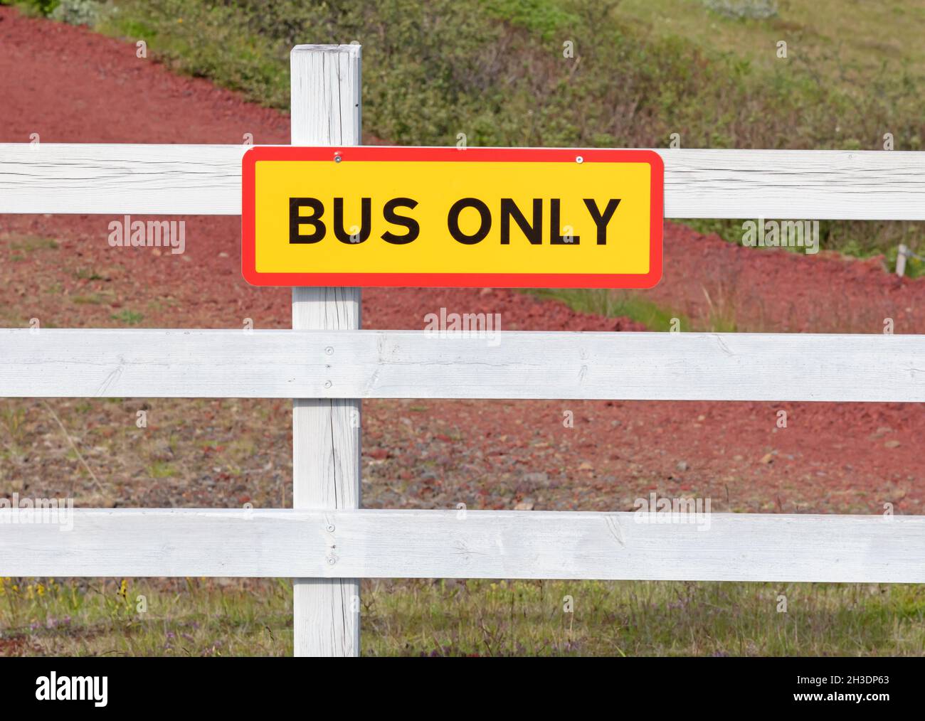 Parking space for the bus only, on a white fence Stock Photo