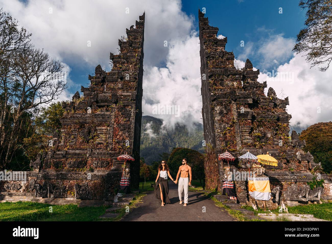 Beautiful couple at the Baltic temple. Man and woman traveling in Indonesia. Couple at the Bali gate. The couple travels the world. Travel to tourist Stock Photo