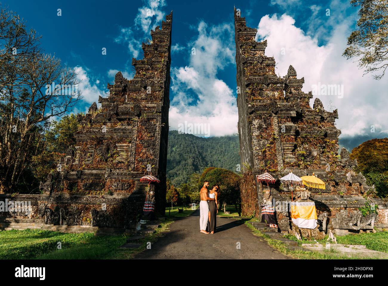 Beautiful couple at the Bali temple. Man and woman traveling in Indonesia. Couple at the Bali gate. The couple travels the world. Travel to tourist Stock Photo