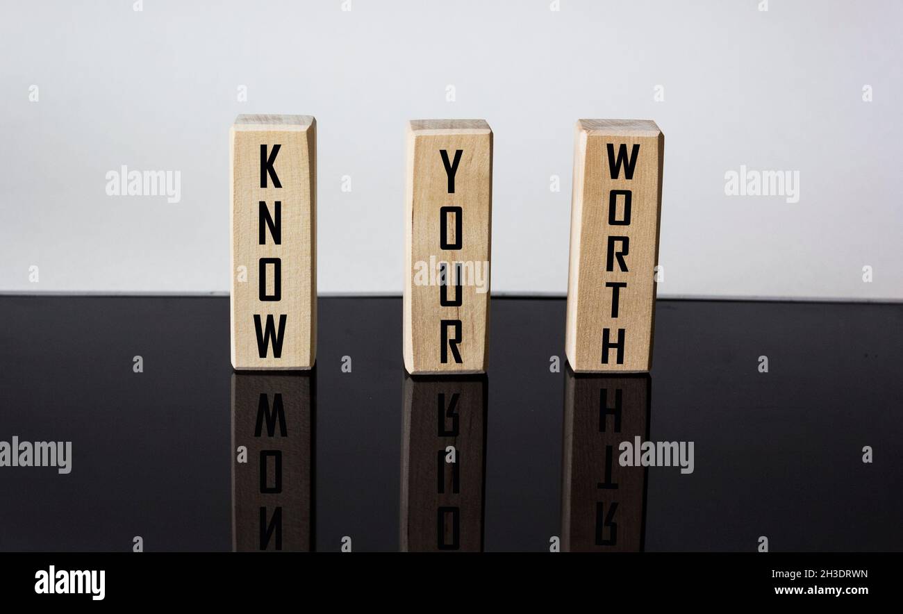 Know your worth on wooden blocks and white and black background. Self motivation coaching HR concept. Stock Photo