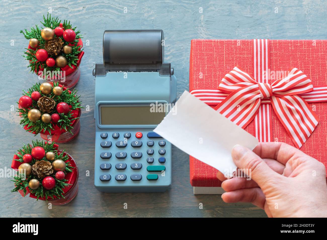 Christmas sale. A hand holding a Blank white check above the cash