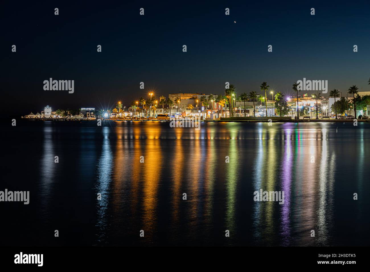 View of the sea and city lights reflection in it at night in Porto Cesareo  Stock Photo - Alamy