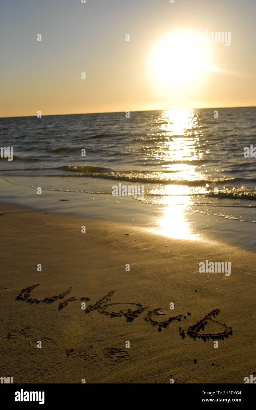 writing 'Urlaub' (holiday) on the beach, Australia Stock Photo