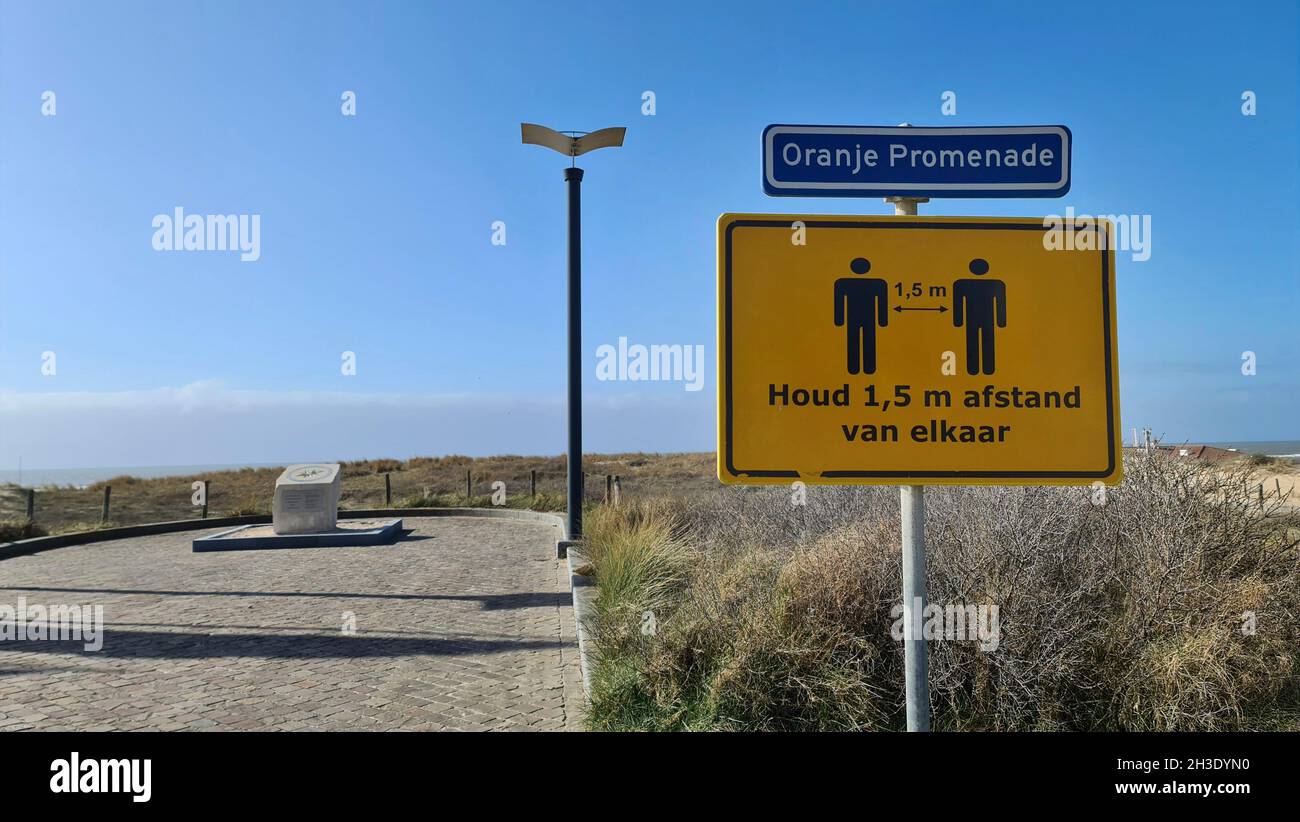 Empty promenade with keep distance sign, Netherlands, Noordwijk aan Zee Stock Photo