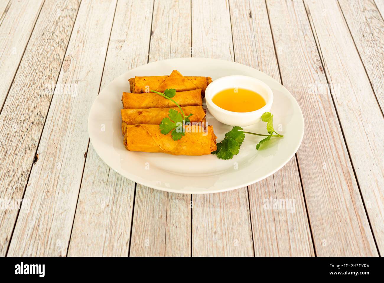 Vietnamese spring rolls fried in oil with crunchy texture and curry sauce Stock Photo