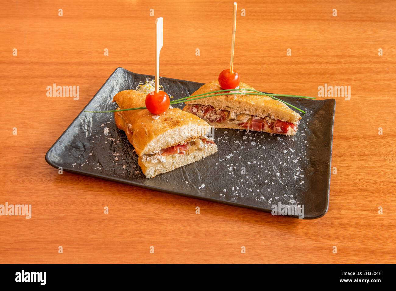 Ham bikini sandwich with truffled tomatoes with grated parmesan cheese on  cherry table Stock Photo - Alamy