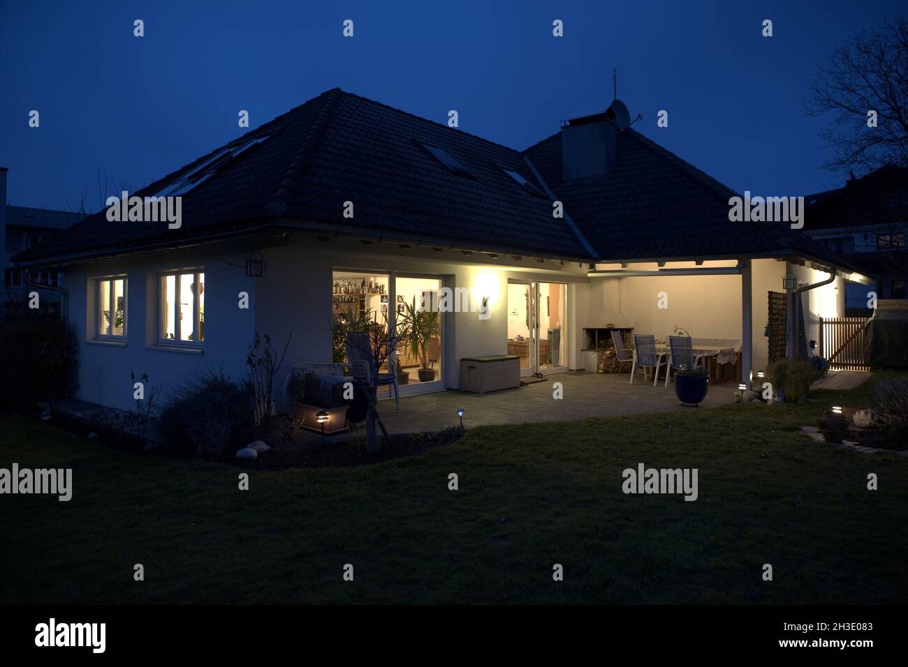 Single-family home illuminated at night, Austria Stock Photo