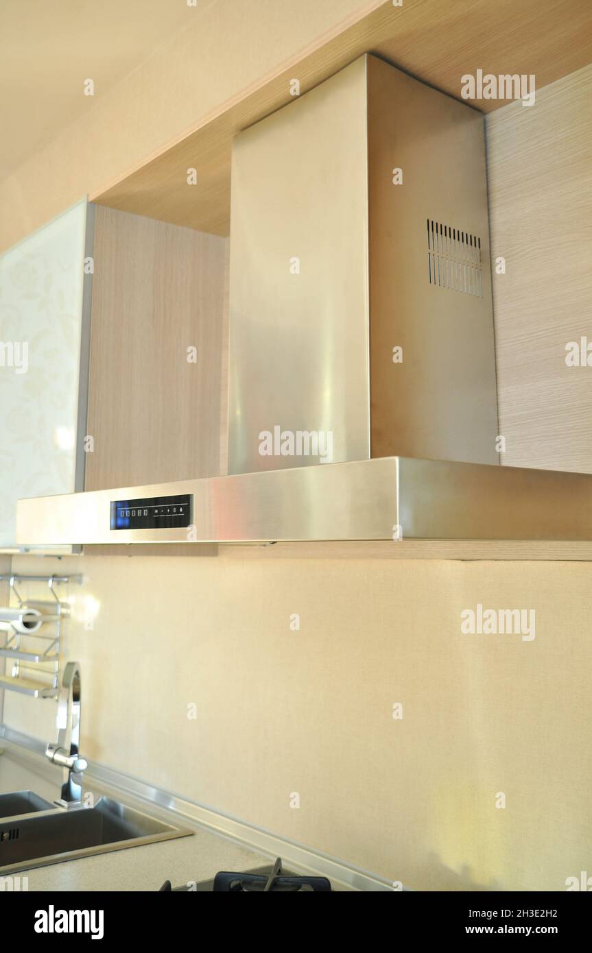 Inox stainless steel hood in a modern kitchen, electric ventilation