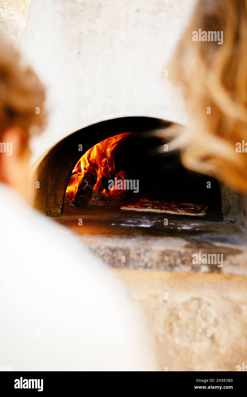 Homemade pizza baking with outdoor traditional pizza over Stock Photo