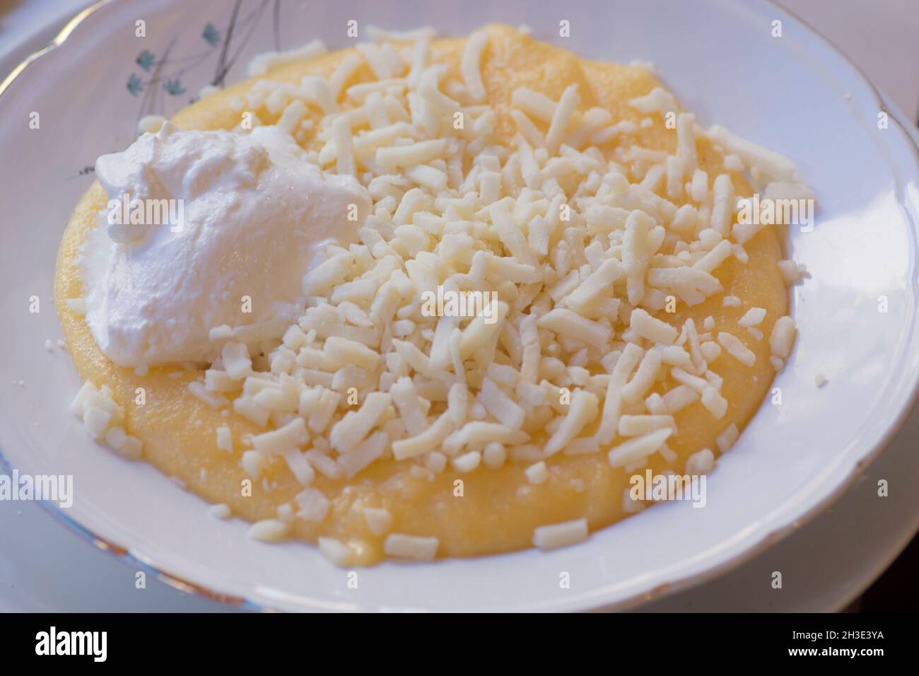 Mamaliga with Cheese, a porridge made out of yellow maize flour, traditional in Romania, Moldova and West Ukraine Stock Photo