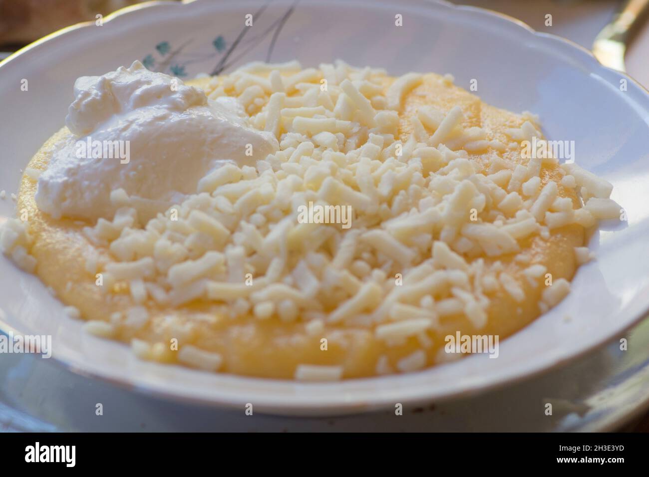 Mamaliga with Cheese, a porridge made out of yellow maize flour, traditional in Romania, Moldova and West Ukraine Stock Photo