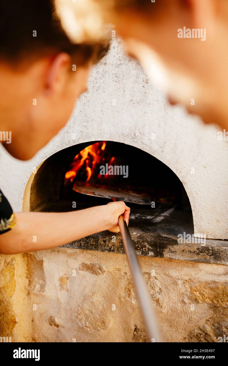 Homemade pizza baking with outdoor traditional pizza over Stock Photo