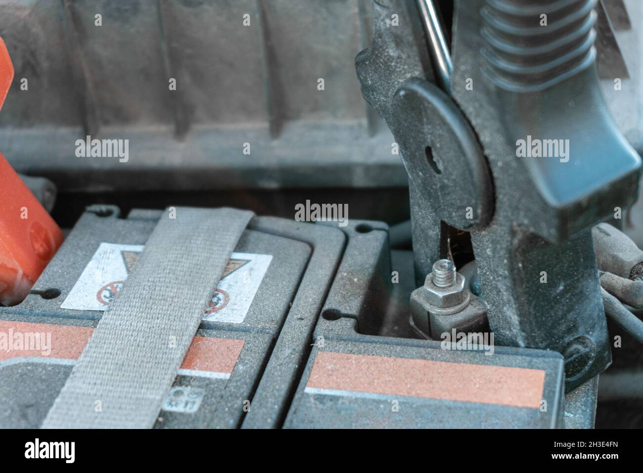 Starter clamps hooked to the terminals of a dusty old car battery Stock