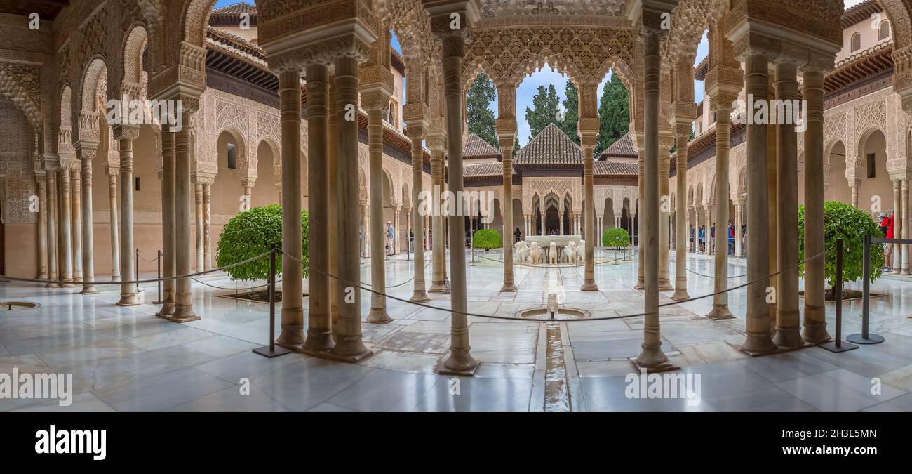 Alhambra Granada Spain - 09 14 2021: Full panoramic exterior view at the Patio at the Lions, twelve marble lions fountain on Palace of the Lions or Ha Stock Photo