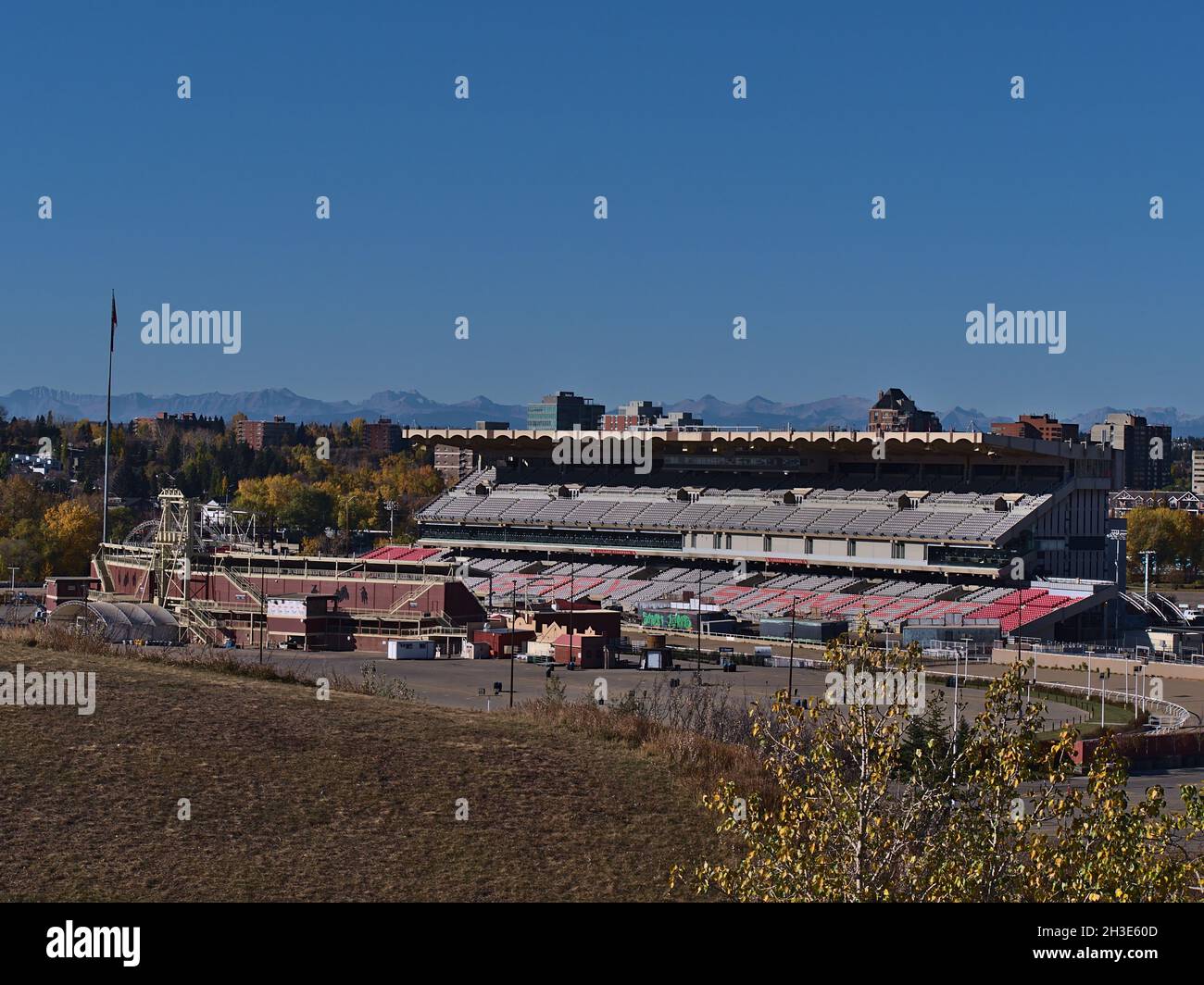 View of the Stampede Grandstand in Calgary, Canada, a stadium with 17,000 seats and standing room for 8,000 people in autumn with the Rockies. Stock Photo